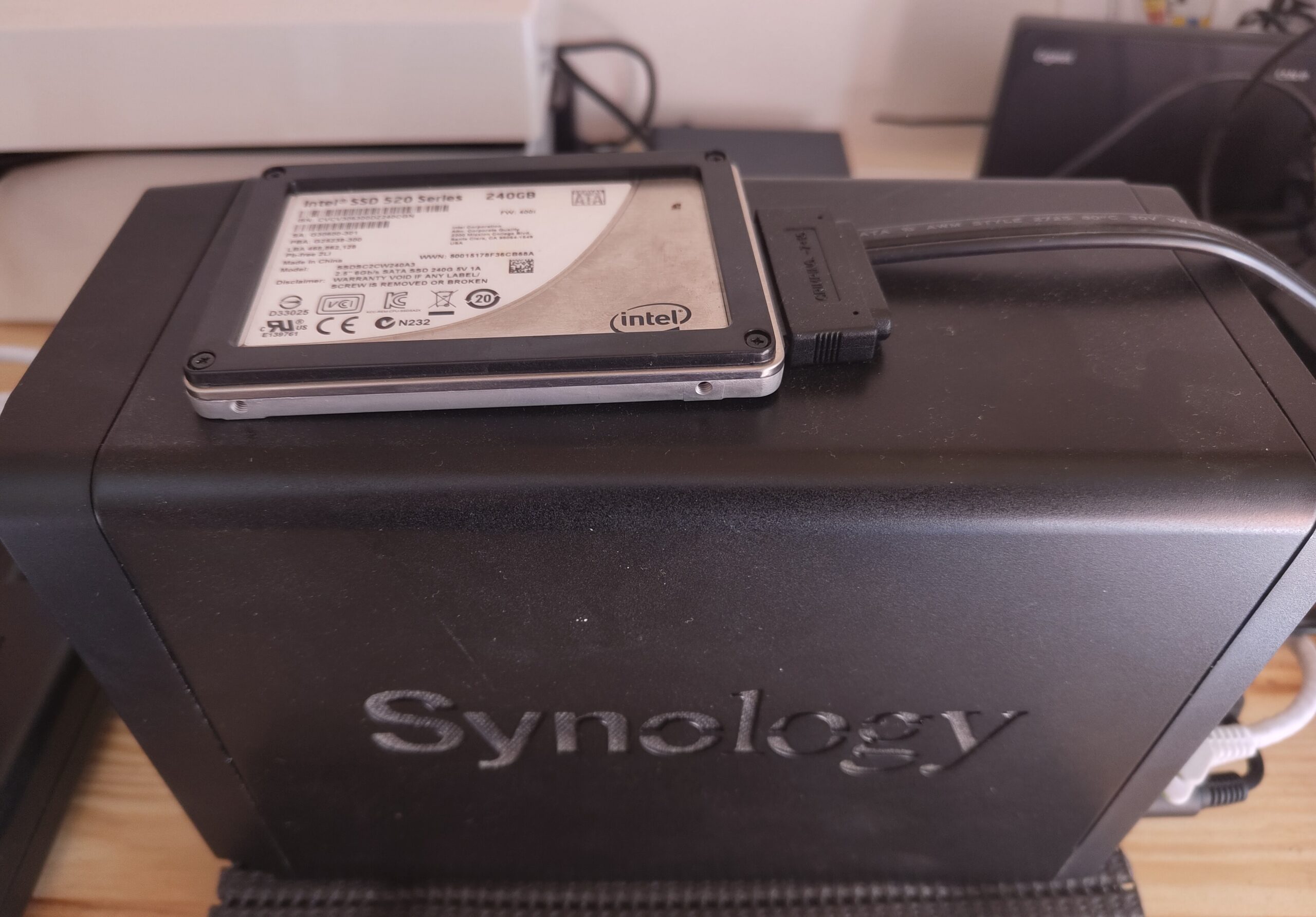 Picture of a Synology NAS with an eSATA-Attached SSD laying on top