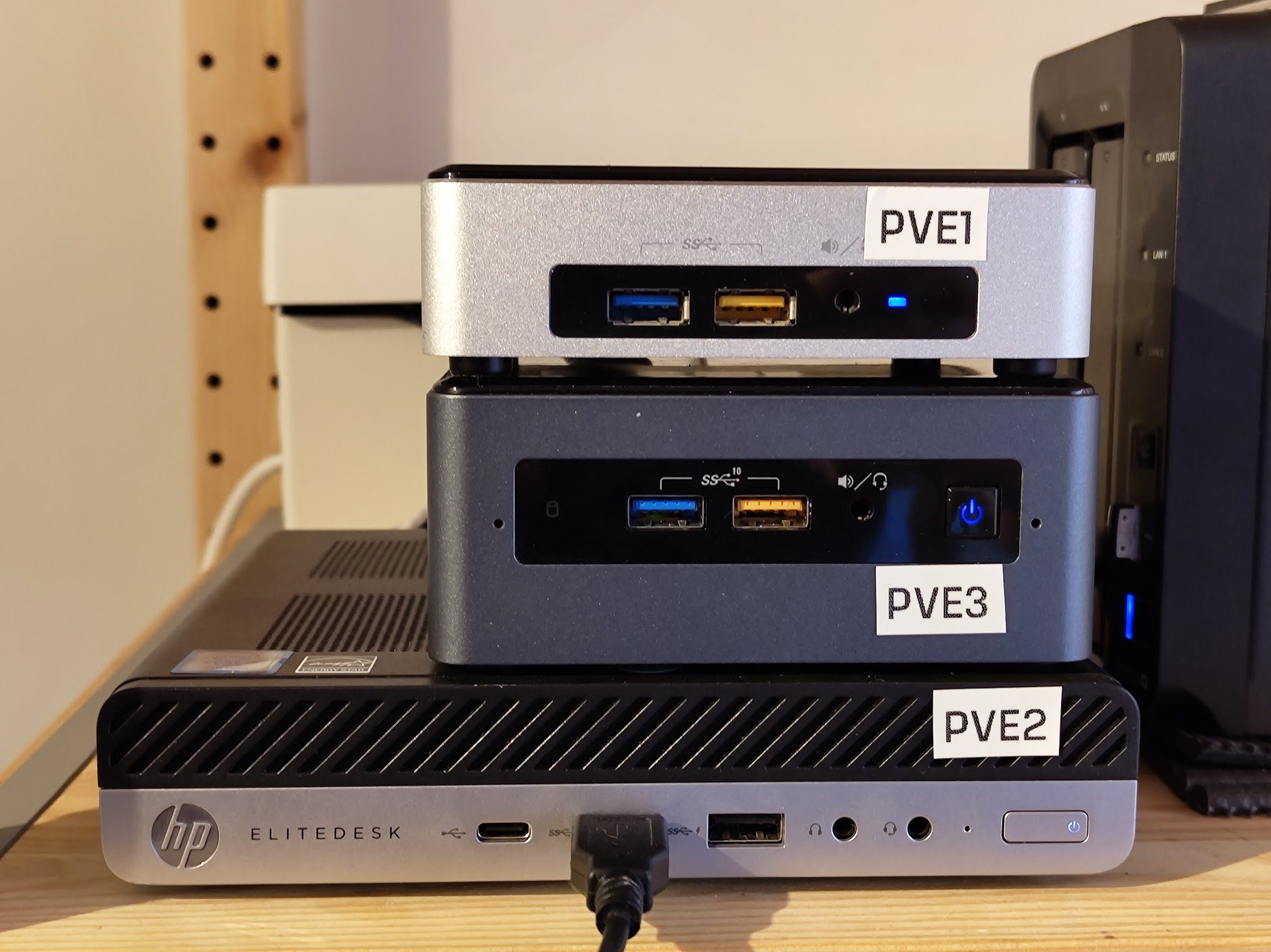 A stack of three computers, labelled PVE1 PVE3 PVE2 on a shelf